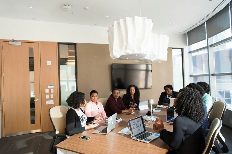 Healthcare administrative billing professionals reviewing accounts and documents at a modern office workstation