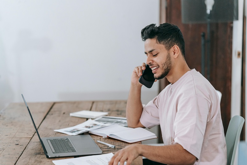 Healthcare billing coordinator reviewing patient account statements and collection records at an administrative workstation