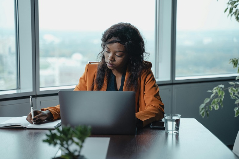 Medical billing specialist processing healthcare claims at a computer